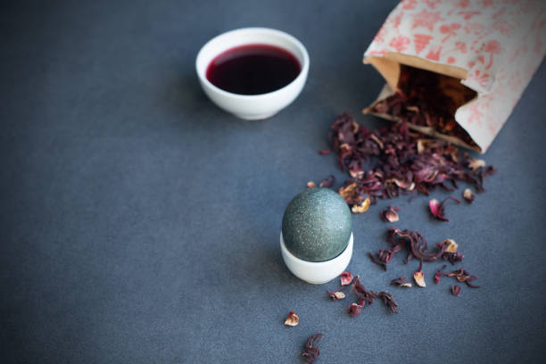 istock How to color easter eggs with natural dye. Grey color from carcade tea. 1304695779