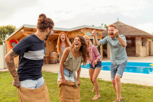 istock Friends jumping in sacks and racing in the backyard 1304695943