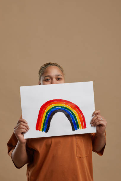 istock Woman Holding Rainbow Sign in Studio 1304696743