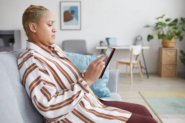 istock Mixed Race Woman using Digital Tablet Side View 1304696760
