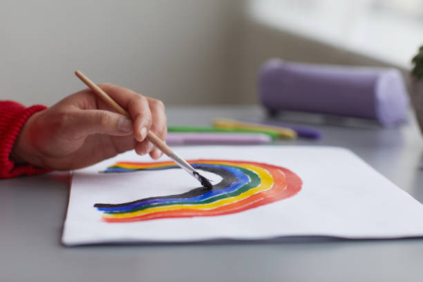 istock Woman Drawing Rainbow Close Up 1304696792