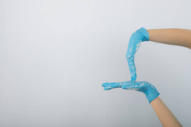 istock Doctor hands with surgical gloves isolated on white background 1304697333
