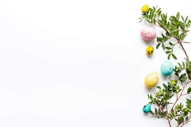 istock Happy Easter with colorful eggs and green branch, top view 1304697577
