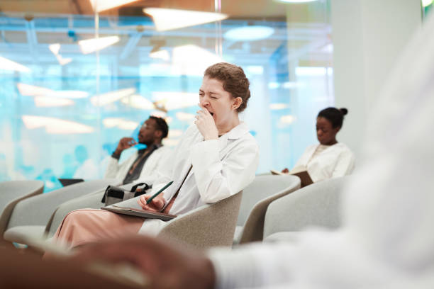 istock Young Woman Yawning at Seminar 1304697692