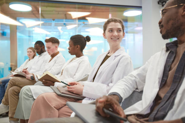 istock Group of Doctors in Row at Seminar 1304697735