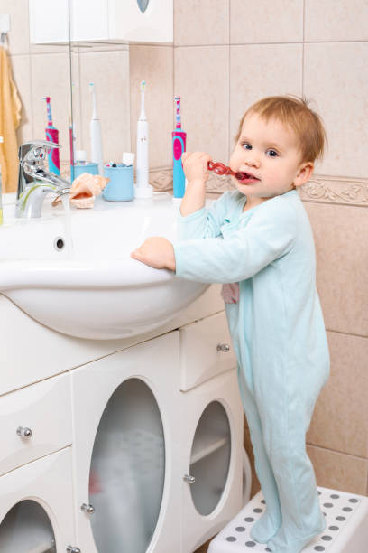 istock Child brushing teeth in a bathroom 1304699514