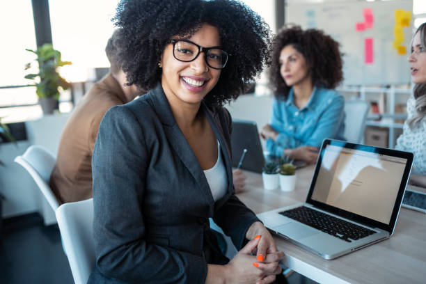 istock Casual multiage business people working with laptops while talking of they new project together in the office. 1304701004