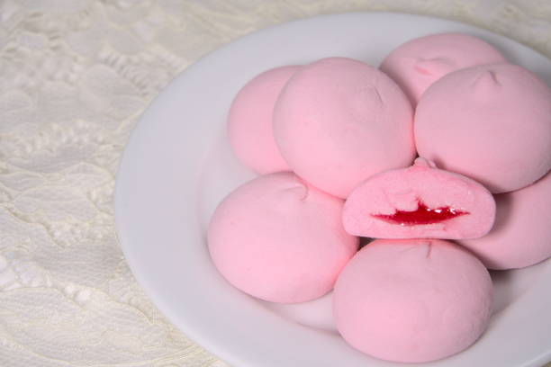 istock Stacked pink buns in a white porcelain plate on the table 1304701043