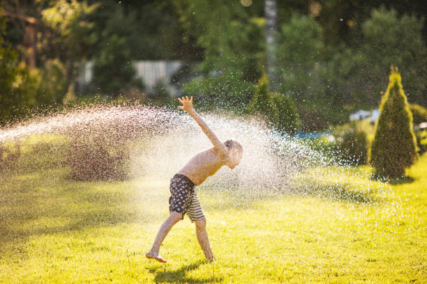istock Father and son playing with water at backyard 1304701713