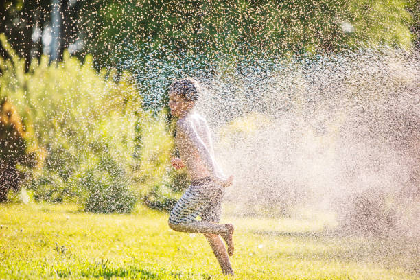istock Father and son playing with water at backyard 1304701761