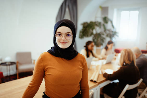 istock Young Middle Eastern woman working in office after reopening, looking at camera 1304701860