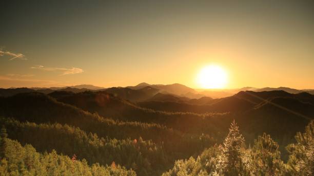 istock Beautiful sunset above mountains; the forest at orange sunset 1304702284