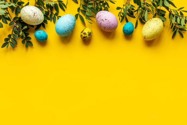 istock Happy Easter with colorful eggs and green branch, top view 1304702420