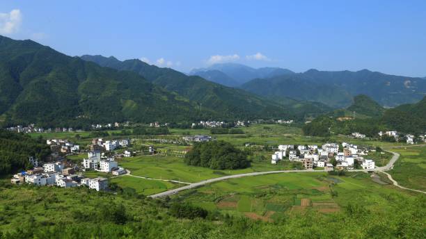 istock Rural scenery in China; green mountains, houses, and fields in spring 1304702443