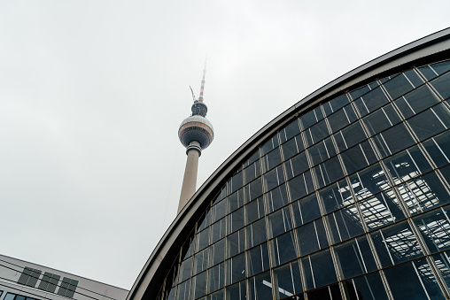 Low angle view of Alexanderplatz railroad station and telecommunication tower in central Berlin.