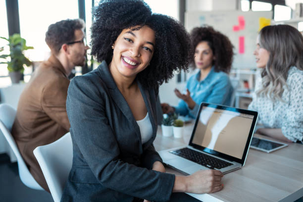 istock Casual multiage business people working with laptops while talking of they new project together in the office. 1304703858