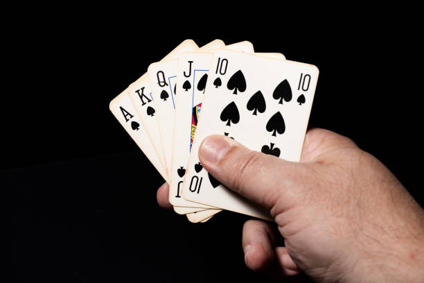 istock Pique royal flush in a poker game. Black background. 1304706723