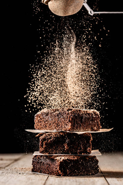 istock Chocolate powder spread on top of brownies 1304708165