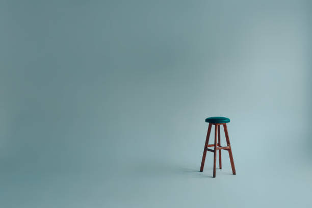 istock Bar stool with upholstered backless seat in an empty white room on a gray background 1304710262