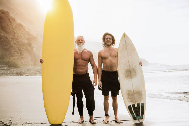istock Multigeneration friends having fun while surfing on beach - Focus on faces 1304711644