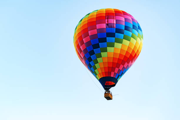 istock Multicolored air balloon in clear blue sky 1304712924
