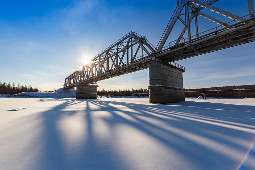 Railway bridge over the Chulman river in South Yakutia, Russia, in winter