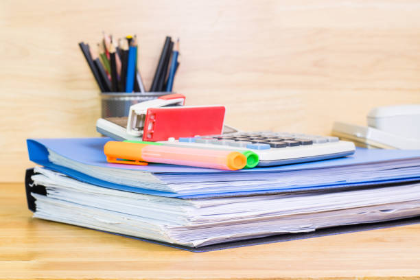 istock file folder and Stack of business report paper file on the table in a work office, concept document in work office 1304713904