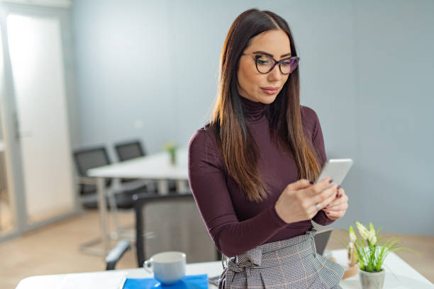 istock Serious businesswoman using phone in office. 1304714186