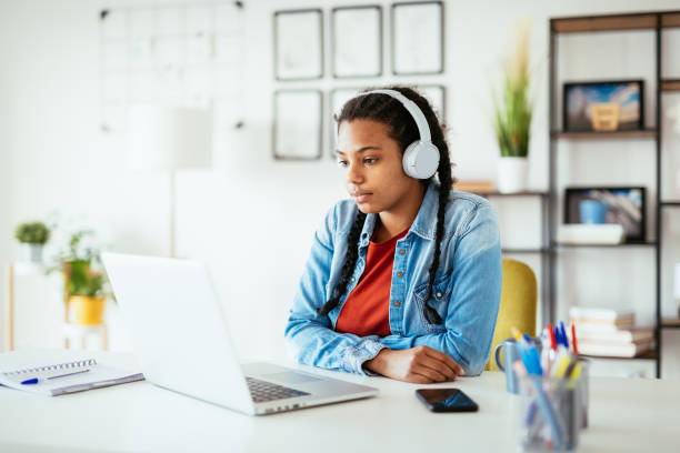 istock African-American student studying on laptop and having video call with professor 1304714229
