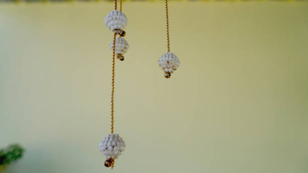 istock White wind chimes with diamonds and golden chain isolated on white background 1304714363
