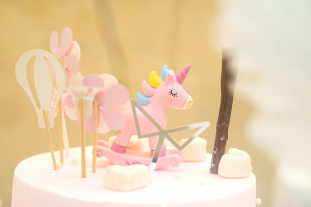 istock Birthday cake with pink unicorn, bokeh background 1304716698