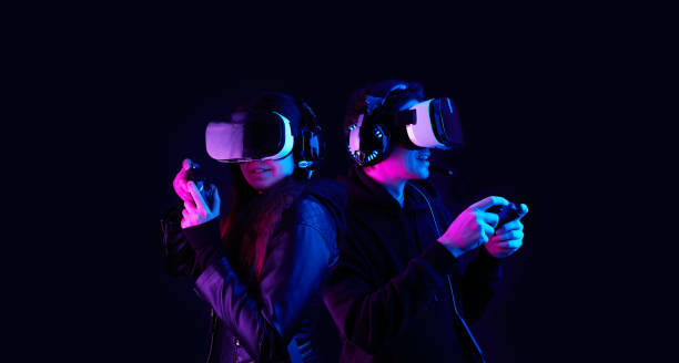 istock Gamers with virtual reality headsets and gamepads. 1304718016