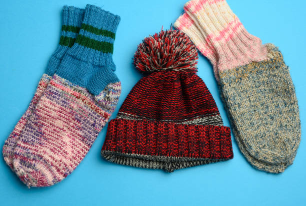istock pair of warm comfortable knitted socks and a knitted hat on a blue background 1304718132