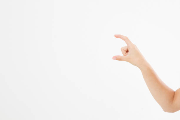 female hand measuring invisible items, woman's palm making gesture while showing small amount of something on white isolated background, side view, close-up, cutout, copy space