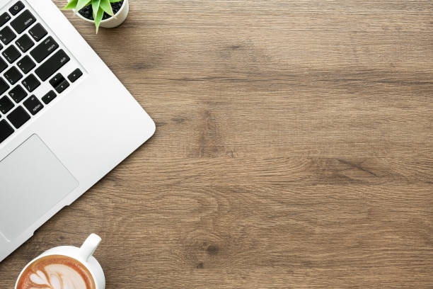 istock Wood office desk table with laptop computer and cup of coffee. Top view with copy space, flat lay. 1304721958