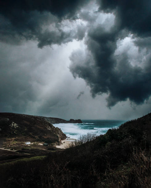 Porthcurno A moody sky above the coastline at Porthcurno fishing village stock pictures, royalty-free photos & images