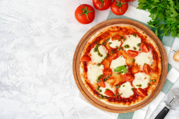 istock Top view of pizza Margherita on gray surface 1304725537