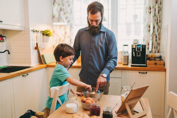 istock Father and son preparing pancake batter together 1304726928