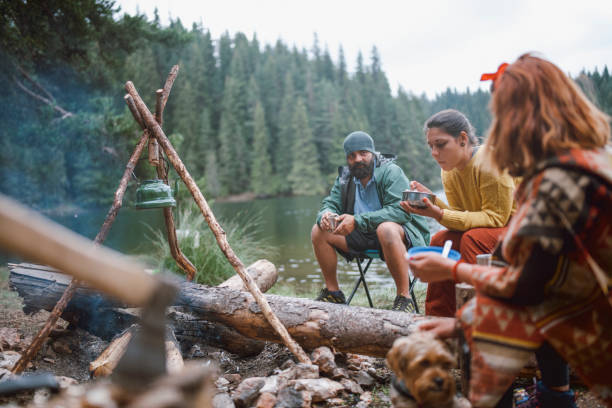 istock Group of friends having a breakfast and talking while camping in the mountain. 1304728442
