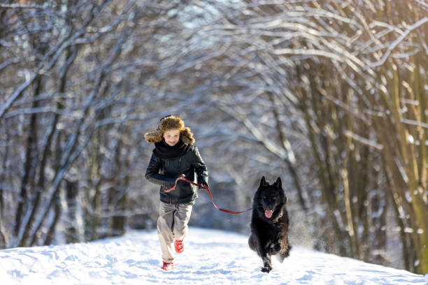 istock Little boy enjoying winter with his dog 1304728846