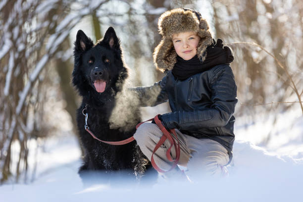 istock Little boy enjoying winter with his dog 1304728872
