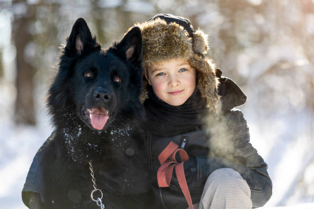 istock Little boy enjoying winter with his dog 1304728878