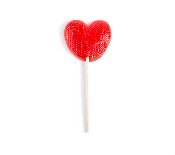 istock Red candy in the form of a heart on a stick for lovers. White background, isolate, close-up 1304729057