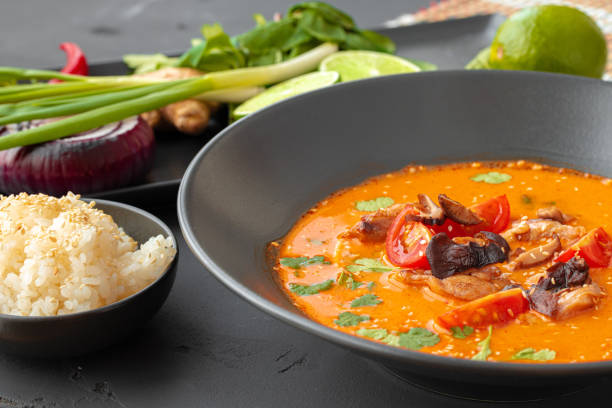 istock Tom Yam Thai soup in black bowl on gray table 1304730566