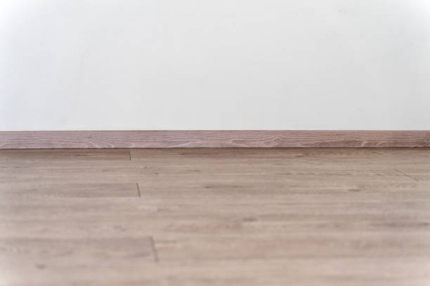 istock background with empty white wall with hardwood floor with plenty of copy space for text or advertising 1304730756
