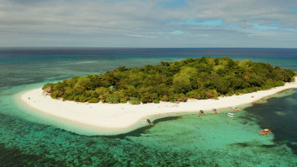 istock Tropical island with sandy beach. Mantigue Island, Philippines 1304730762