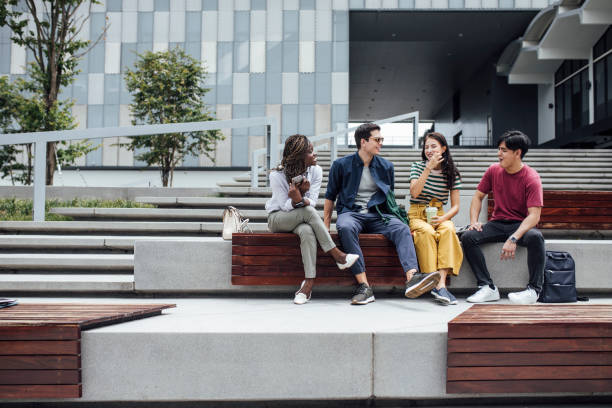 istock University Students Sitting Outdoors 1304731790
