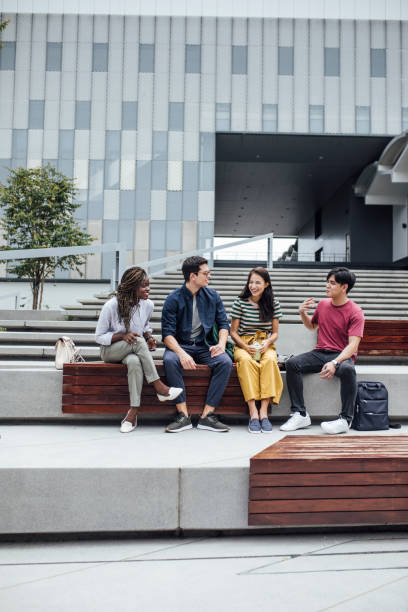 istock University Students Sitting Outdoors 1304731795