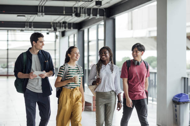 istock Happy University Students Walking in Hallway 1304731828