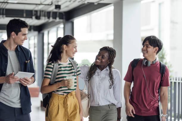 istock Smiling University Students Walking in Hallway 1304731840
